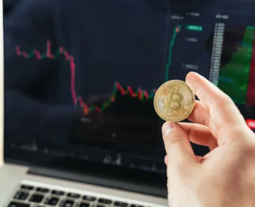 crypto trader hands with golden bitcoin